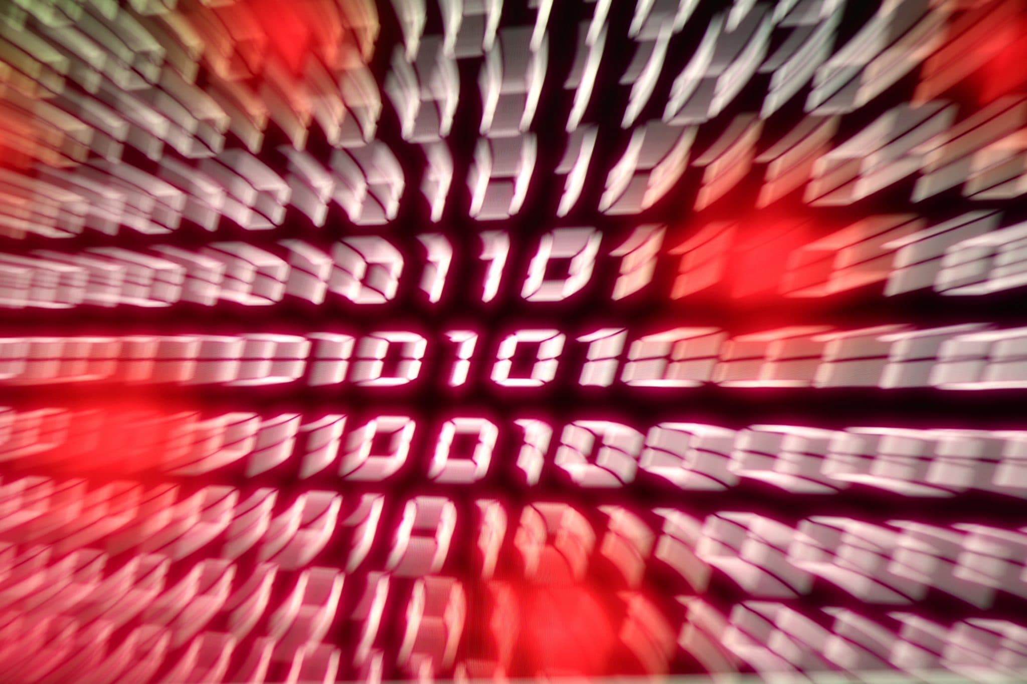 A stock image of binary popping out of a computer screen