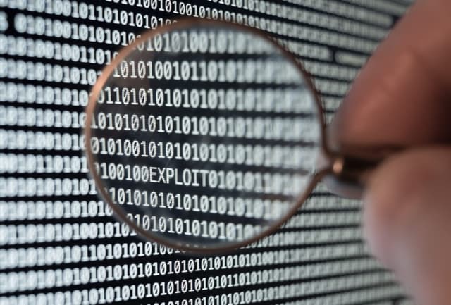 A stock image of a magnifying glass on a computer screen